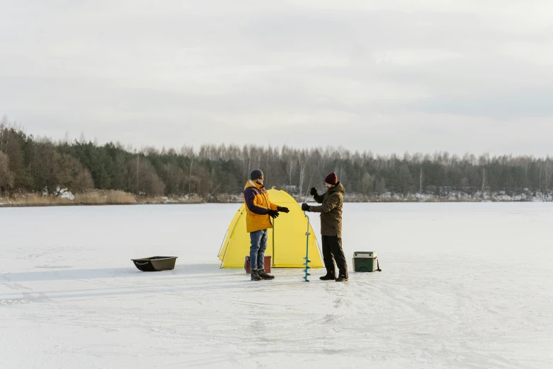 a couple of people standing on top of a snow covered field, by Veikko Törmänen, hurufiyya, people angling at the edge, yellow, tent, product introduction photo