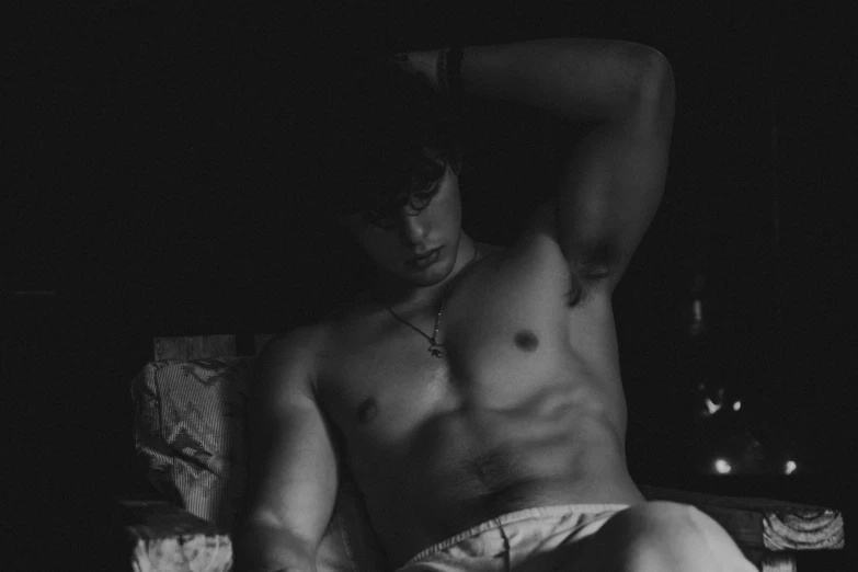 a black and white photo of a shirtless man, a black and white photo, by Emma Andijewska, pexels contest winner, renaissance, ✨🕌🌙, laying on a bed, wonbin lee, ash thorp khyzyl saleem