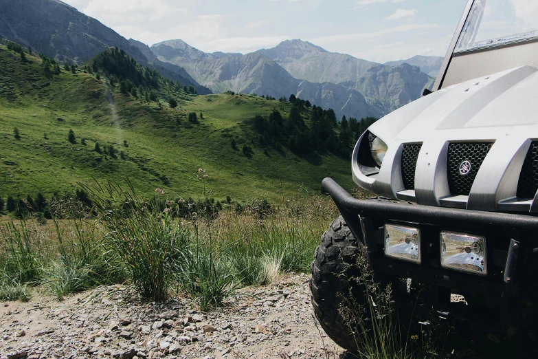 a white truck parked on the side of a dirt road, by Raphaël Collin, unsplash, figuration libre, tesla dune buggy, the alps are in the background, avatar image, banner