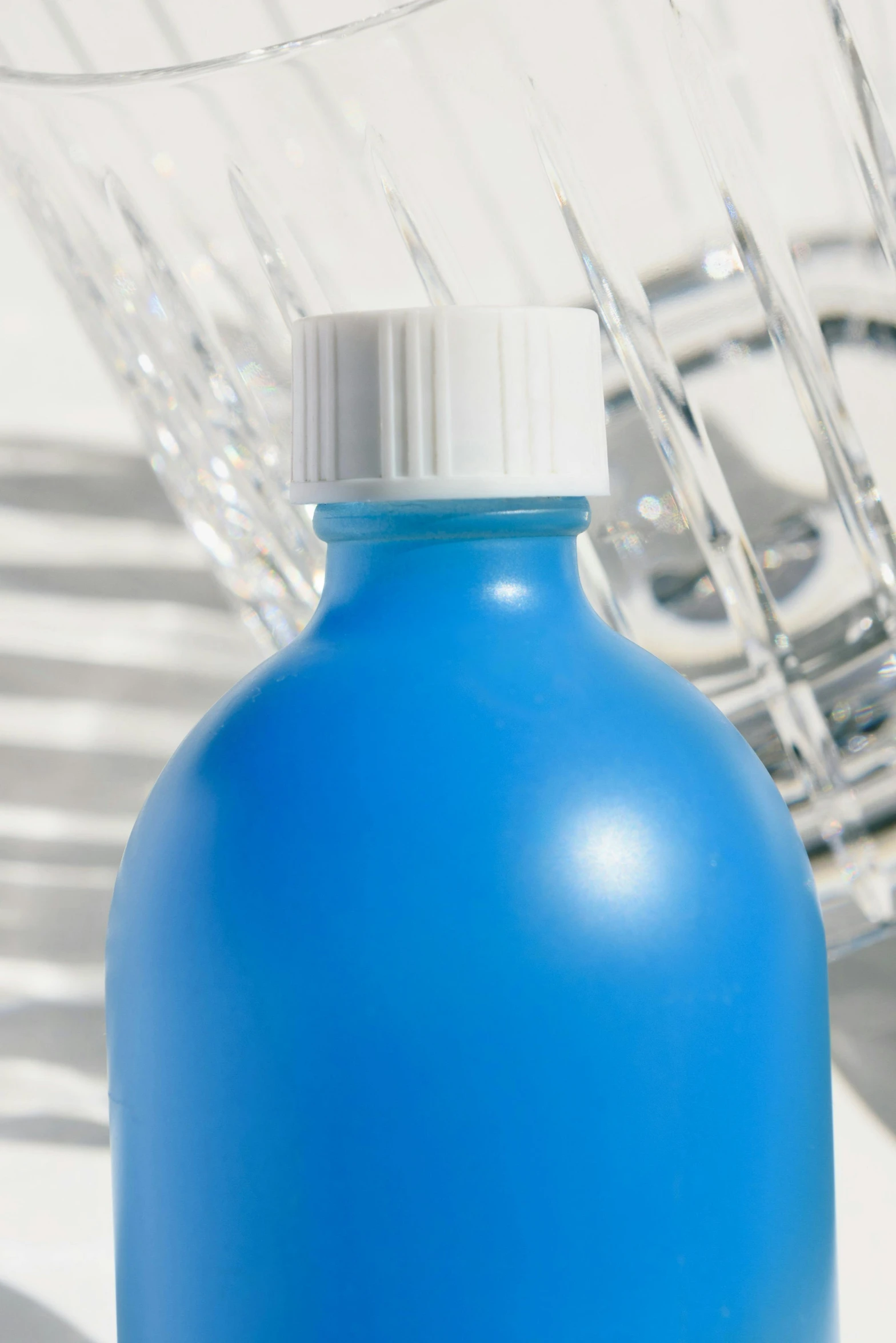 a bottle of blue liquid next to a wire basket, by Doug Ohlson, plasticien, neck zoomed in, promo image, detail, units