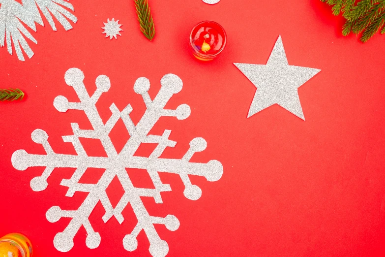 a snowflake and christmas decorations on a red background, trending on pexels, knolling, background image, alex heywood, glitter sticker