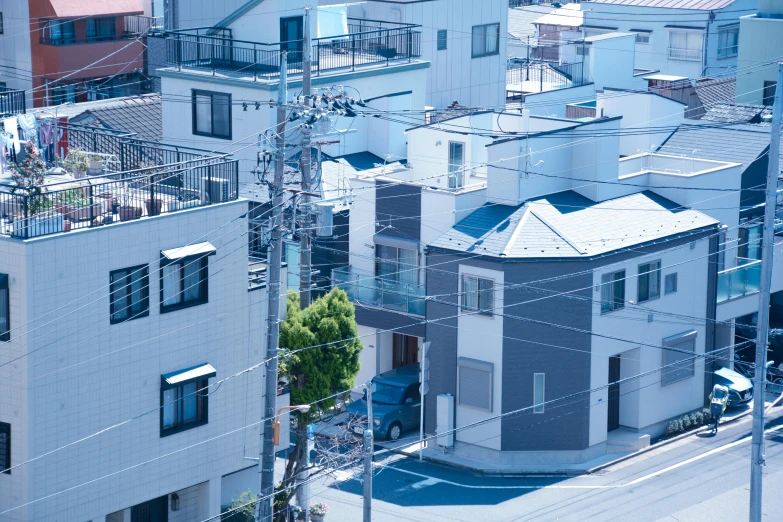 a city street filled with lots of tall buildings, a picture, unsplash, shin hanga, japanese house, blue gray, in a suburb, tatsuro kiuchi