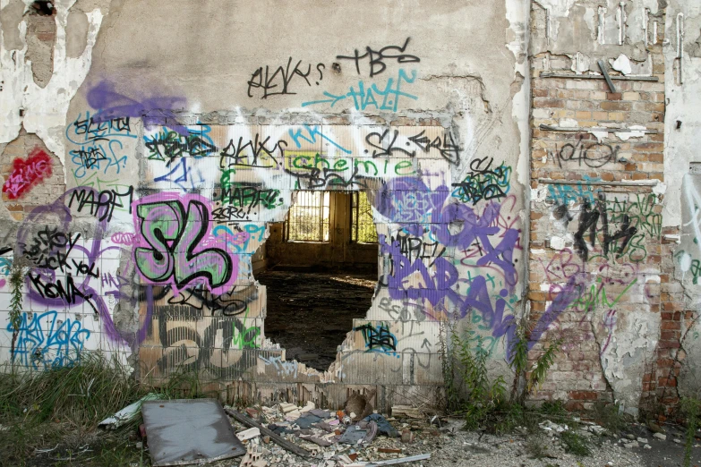 a bunch of graffiti on the side of a building, pexels contest winner, inside a haunted destroyed house, metal framed portal, location [ chicago ( alley ) ], huge old ruins