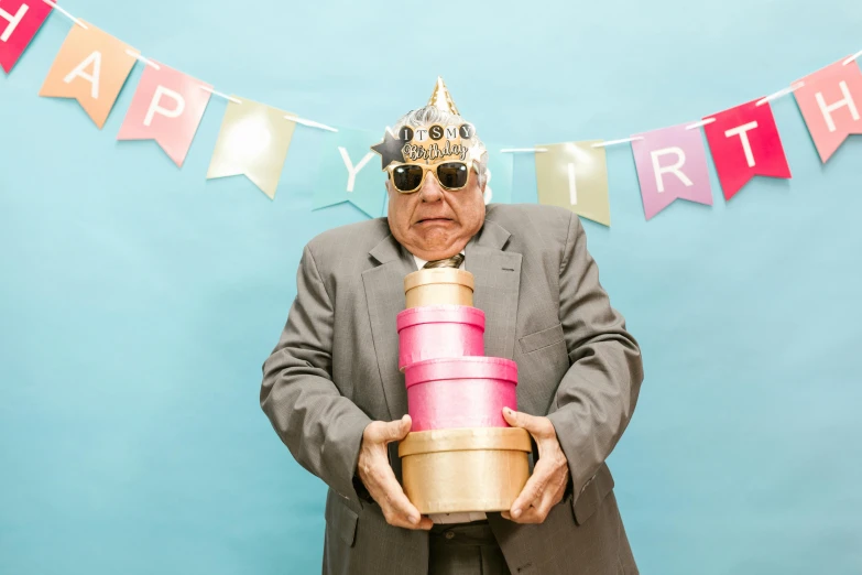 a man wearing a crown holding a birthday cake, by Alice Mason, pexels contest winner, an oldman, plain background, an obese, hat covering eyes