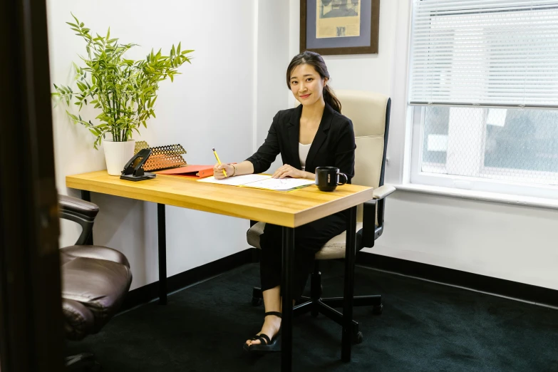 a woman sitting at a desk in an office, by Simon Gaon, darren quach, sitting at a desk, brown