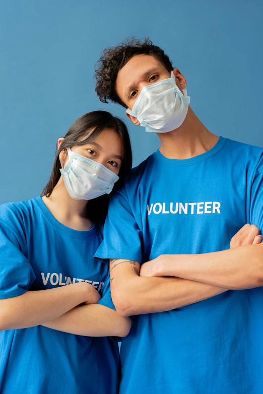 a man and a woman wearing face masks, pexels contest winner, lab coat and tee shirt, blue wall, thumbnail, support