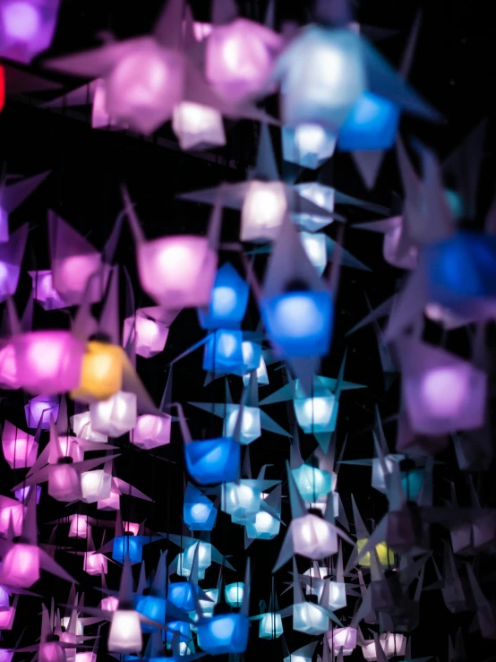 a bunch of colorful lights hanging from a ceiling, interactive art, glowing paper lanterns, upclose, bioluminescent cyber - garden, cool purple slate blue lighting