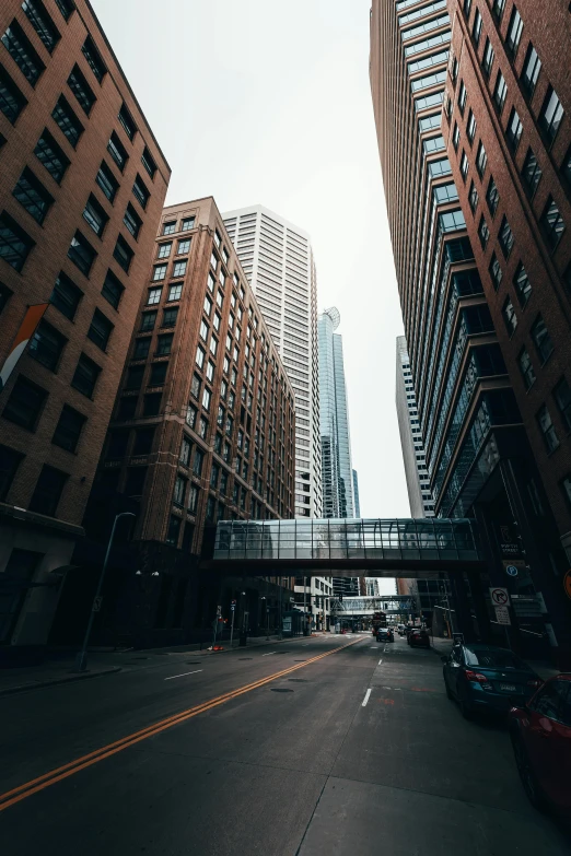 a city street filled with lots of tall buildings, inspired by Thomas Struth, pexels contest winner, michigan, sky bridge, typical, cinematic lut