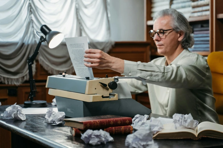 a man sitting at a desk with a typewriter, a photocopy, pexels contest winner, white reading glasses, man carving himself out of stone, anomalisa, avatar image