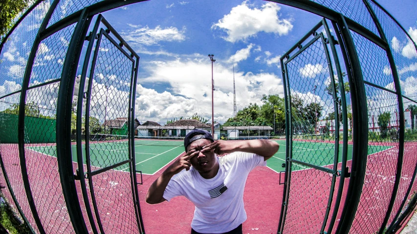 a man standing on top of a tennis court holding a racquet, an album cover, pexels contest winner, ((fish eye)), riyahd cassiem, playground, battle pose