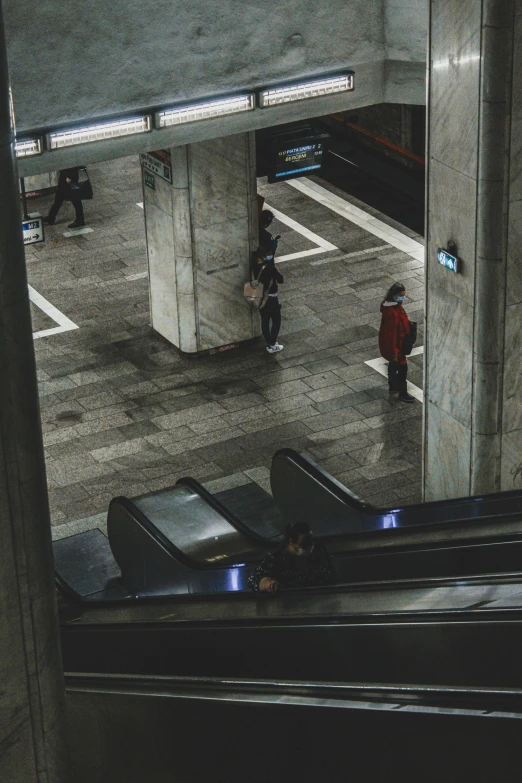 a group of people riding down an escalator, pexels contest winner, hyperrealism, dark city bus stop, square, high view, low quality photo