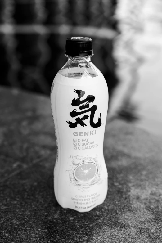 a bottle of water sitting on top of a table, a black and white photo, inspired by Sengai, shenron, yogurt, garnish, japanese typography