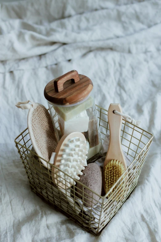 a basket filled with items sitting on top of a bed, pexels, dry brushing, textured base ; product photos, creamy, eeri