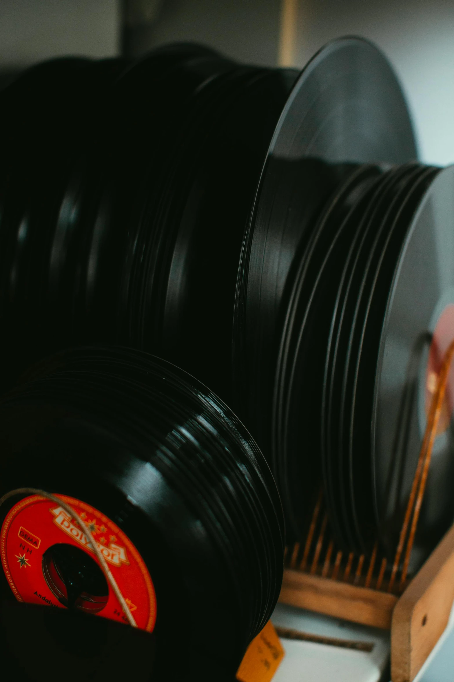 a stack of vinyl records sitting on top of a shelf, an album cover, trending on pexels, plasticien, low quality photo, thick looping wires, cinematic image, plain background