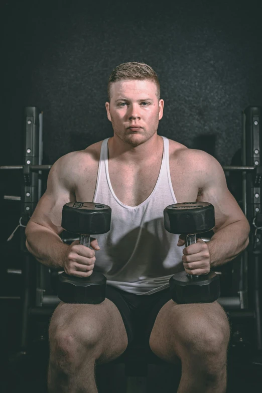 a man sitting on a bench holding two dumbs, pexels contest winner, chris evans as a powerlifter, headshot profile picture, connor hibbs, thrusters