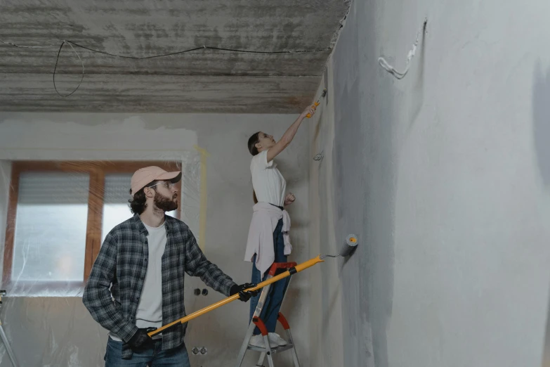 a couple of men standing on top of a ladder, a hyperrealistic painting, pexels contest winner, simple ceiling, background image, under construction, australian