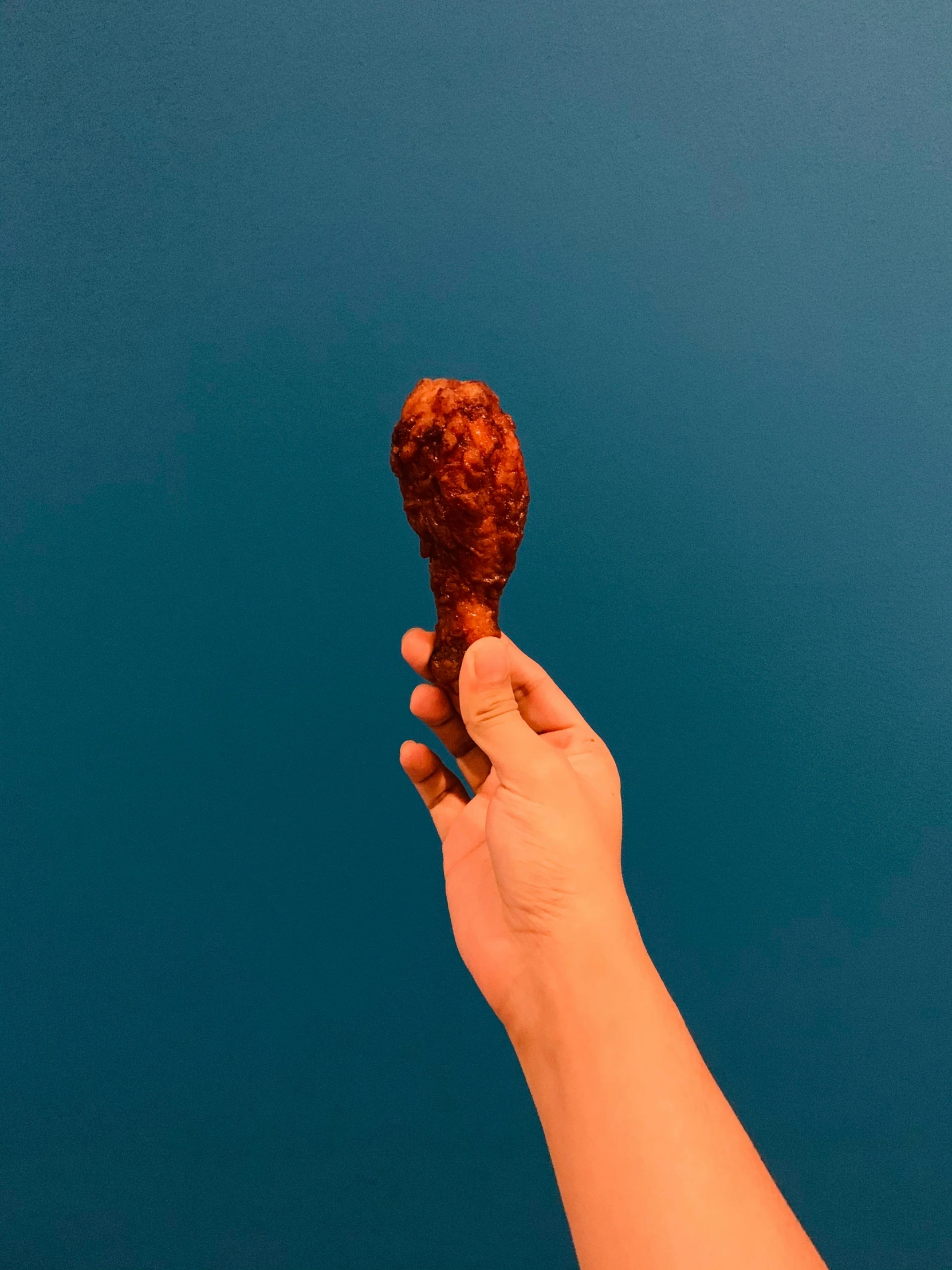 a person holding an ice cream cone in their hand, chorizo sausage, sky view, made of lava, sydney hanson