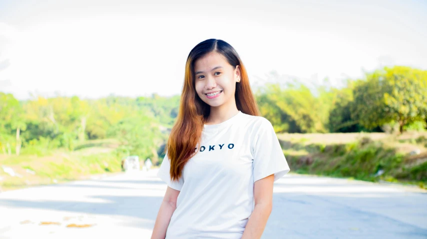 a woman standing on the side of a road holding a skateboard, by Sengai, unsplash, hurufiyya, wearing a t-shirt, avatar image, background image, portrait of a japanese teen