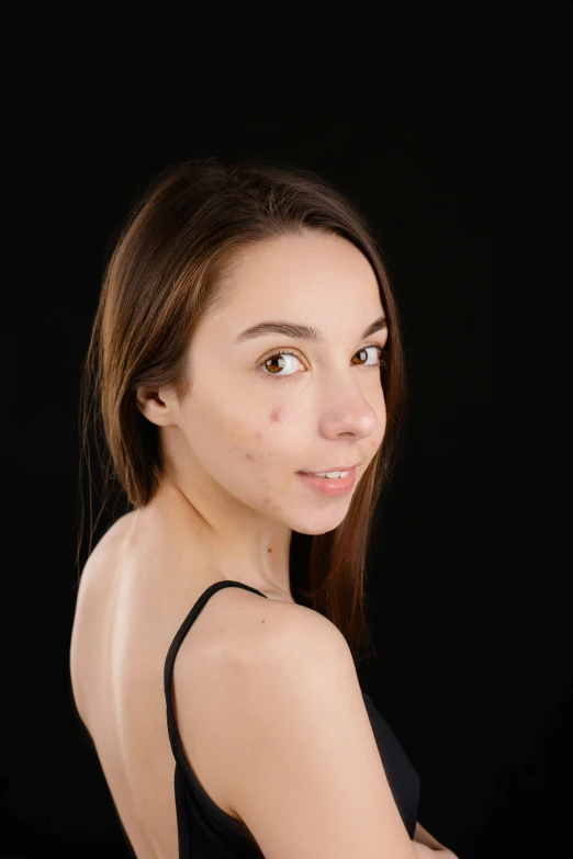 a woman in a black dress posing for a picture, by Adam Marczyński, reddit, antipodeans, facial scar, in a photo studio, 1 6 years old, smooth textured skin