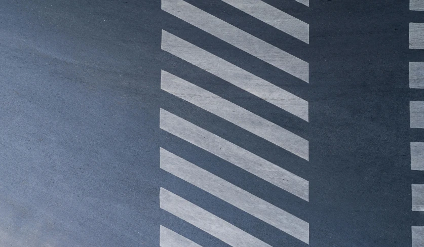 a red fire hydrant sitting on the side of a road, an album cover, by Harvey Quaytman, unsplash, op art, blue and grey, floor texture, trimmed with a white stripe, trending on dezeen