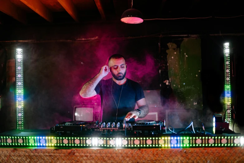 a man that is standing in front of some lights, mixing drinks, sam nassour, faded and dusty, performing