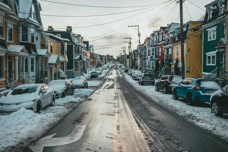 a street filled with lots of snow next to tall buildings, by Clément Serveau, pexels contest winner, parked cars, colonial era street, 🦩🪐🐞👩🏻🦳, grey