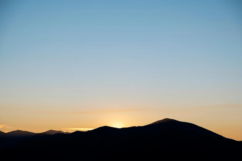 the sun is setting over a mountain range, by Carey Morris, trending on unsplash, minimalism, blue: 0.5, new hampshire mountain, two suns, taken in the late 2010s