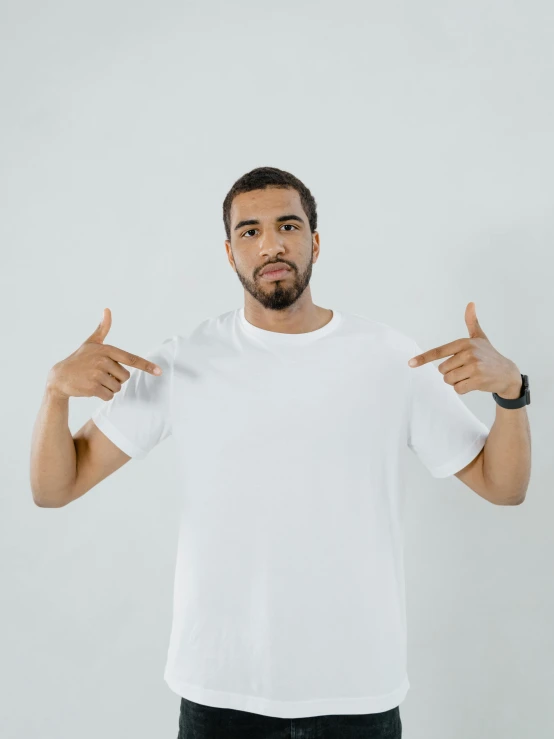 a man in a white t - shirt showing thumbs up, by Christopher Williams, drake, low quality photo, clean symmetrical faces, no - text no - logo