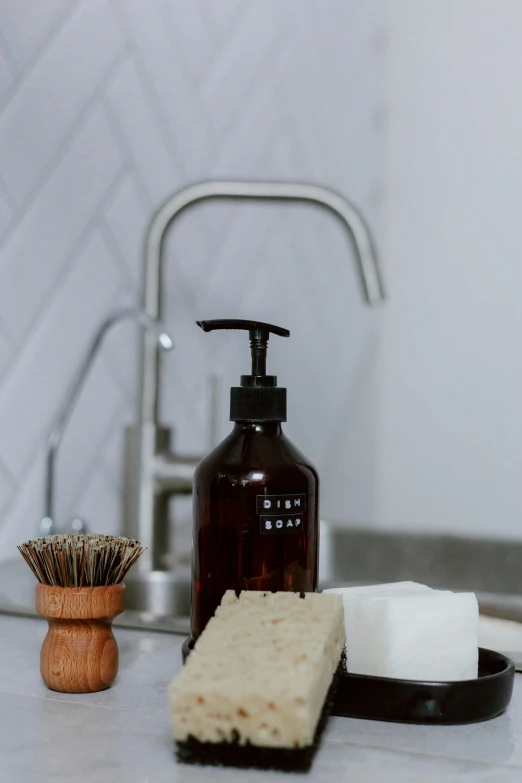 a bathroom counter with soap, brush and soap dispenser, by Ben Zoeller, brown resin, bottle, worn, eco