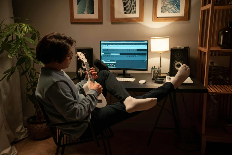 a person sitting in a chair in front of a computer, an album cover, pexels contest winner, studio room, (night), mixing, indoor scene