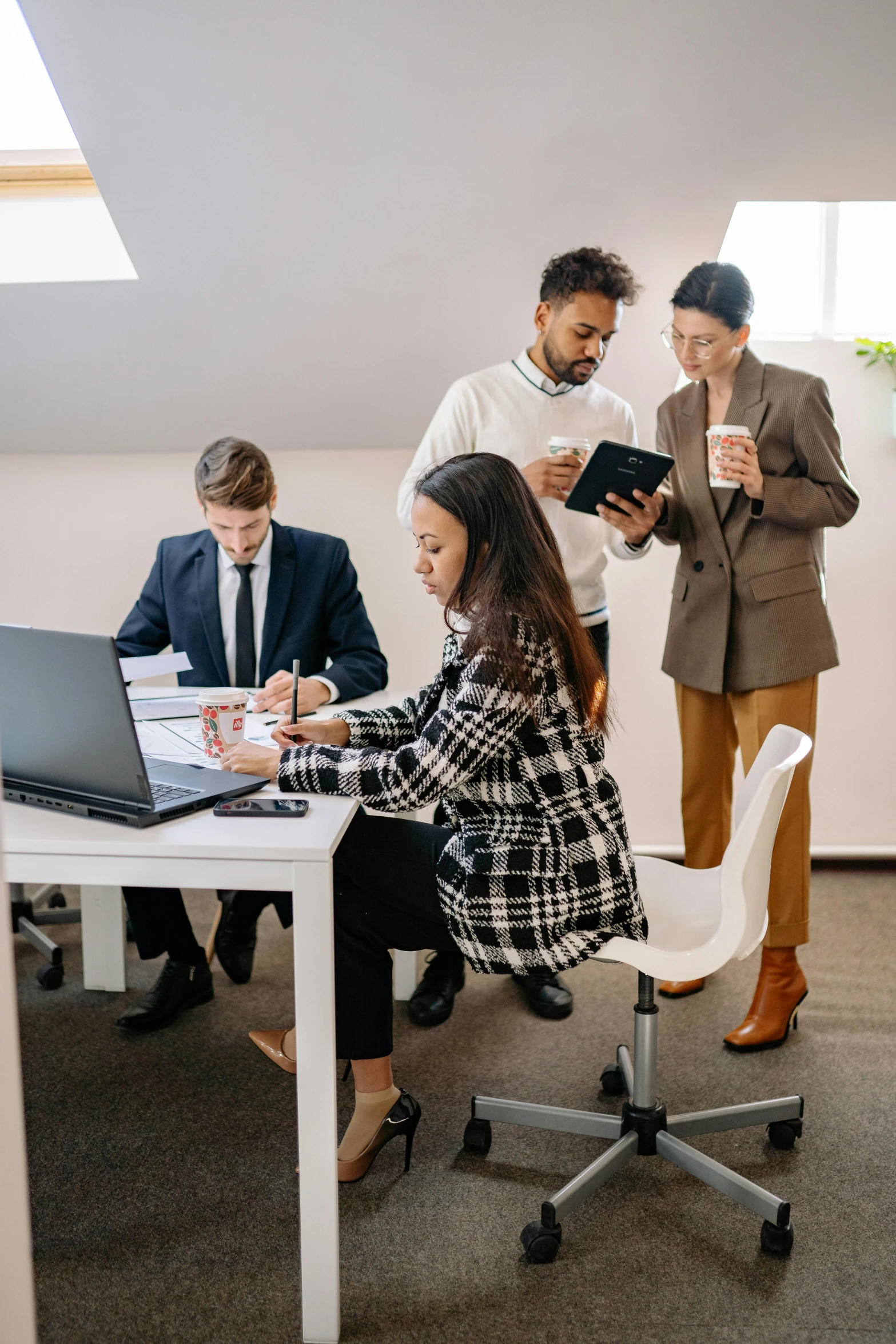 a group of people sitting around a table working on laptops, by Carey Morris, pexels contest winner, standing on a desk, decorative, guide, serious business