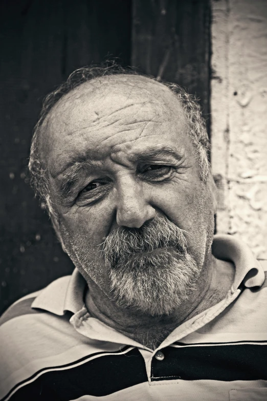 a black and white photo of a man with a beard, inspired by Mario Sironi, pexels contest winner, photorealism, color photograph portrait 4k, danny de vito, mediterranean, ernest gary gygax face