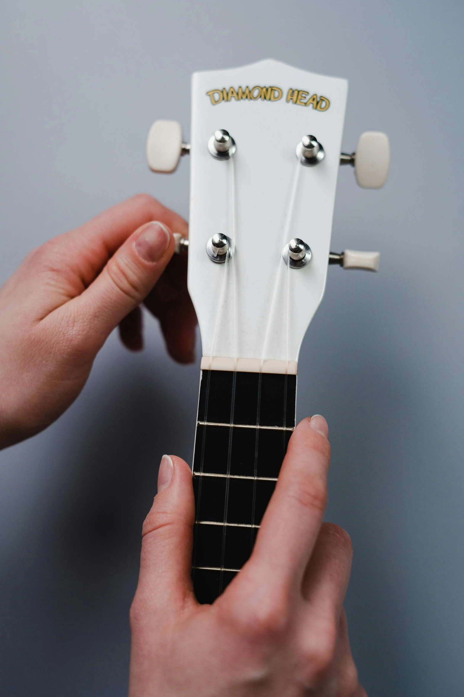 a close up of a person holding a guitar, adafruit, detailed product image