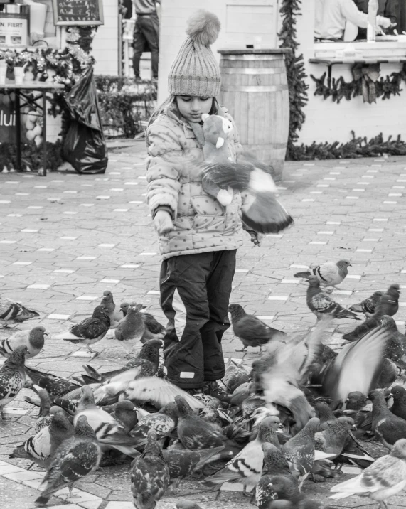 a black and white photo of a child feeding pigeons, a black and white photo, process art, in a square, mittens, birds f cgsociety, color splash
