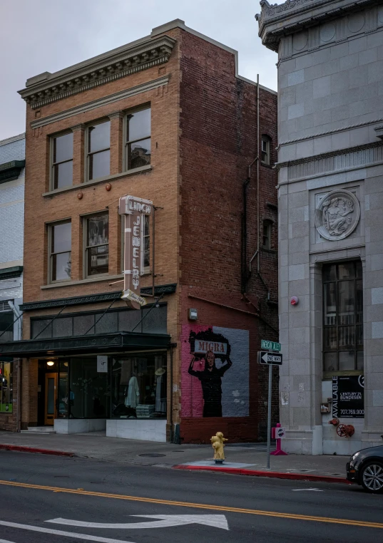 a yellow fire hydrant sitting on the side of a road, by Tom Bonson, renaissance, pink marble building, storefronts, calarts, long shot from back