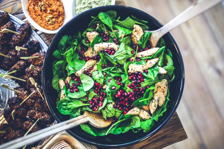 a bowl of food sitting on top of a wooden table, by Carey Morris, pexels, greens, 💋 💄 👠 👗, people inside eating meals, sparkling