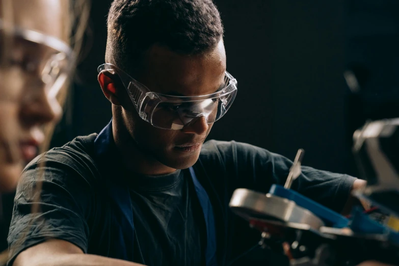 a man with goggles working on a model, pexels contest winner, worksafe. instagram photo, black, 1 1 1 1, plating