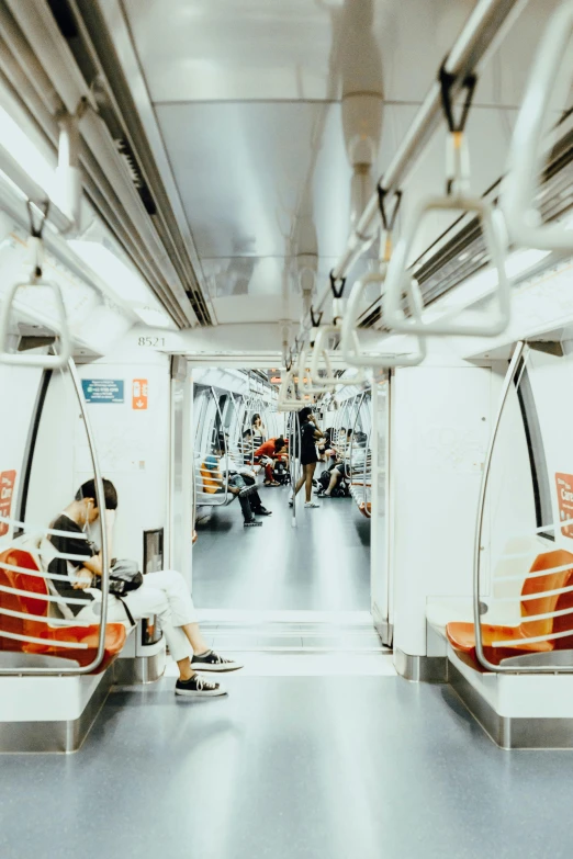 a couple of people that are sitting on a train, by Jason Chan, unsplash contest winner, hypermodernism, single line, spacious, futuristic interior, sparsely populated