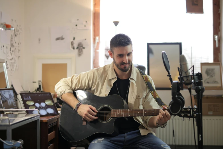 a man that is sitting down with a guitar, sitting in front of a microphone, avatar image, raphael lecoste, thumbnail