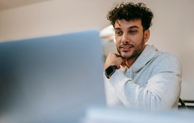 a man sitting in front of a laptop computer, trending on pexels, renaissance, young greek man, lachlan bailey, close angle, thumbnail