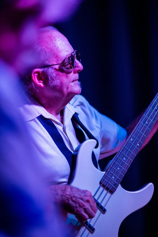 a close up of a person playing a guitar, bassist, an oldman, light blues, graeme base