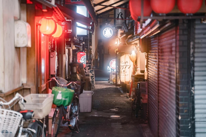 a couple of bikes parked next to each other on a street, unsplash contest winner, ukiyo-e, dive bar with a karaoke machine, quiet tokyo alley at night, vendors, in an alley at night back lit