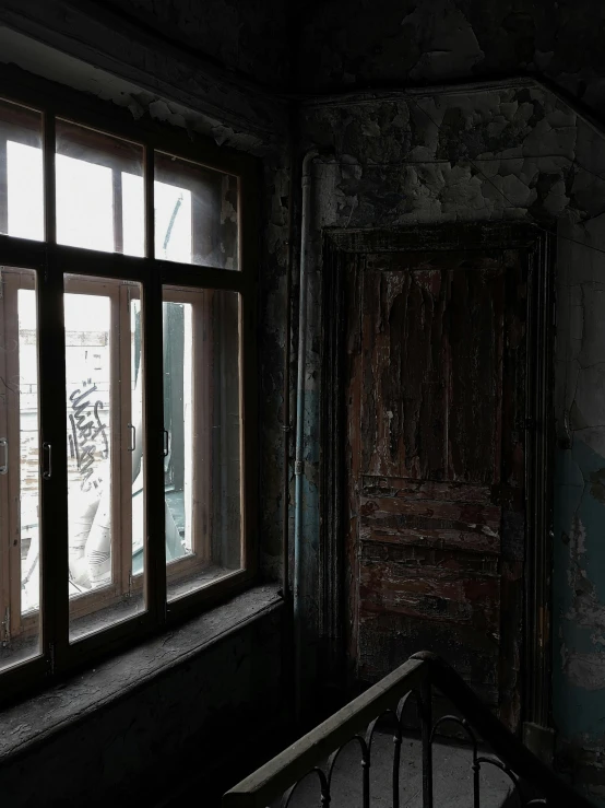 a close up of a window in a building, inspired by Elsa Bleda, pexels contest winner, graffiti, haunted house interior, background image, hashima island, dark and muted colors