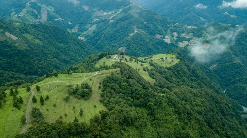 an aerial view of a lush green mountain range, by Muggur, pexels contest winner, renaissance, city of armenia quindio, solo hiking in mountains trees, taiwan, profile image