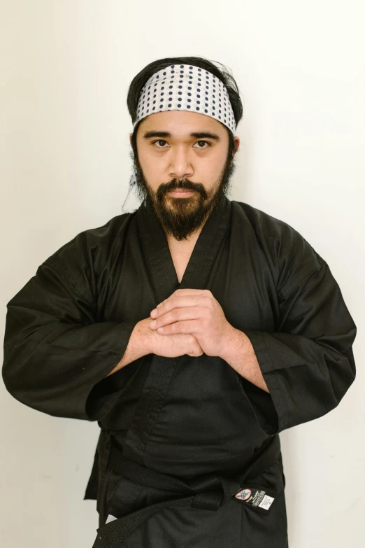 a man in a black kimono posing for a picture, ninja jesus, looking serious, taken in the early 2020s, david villegas