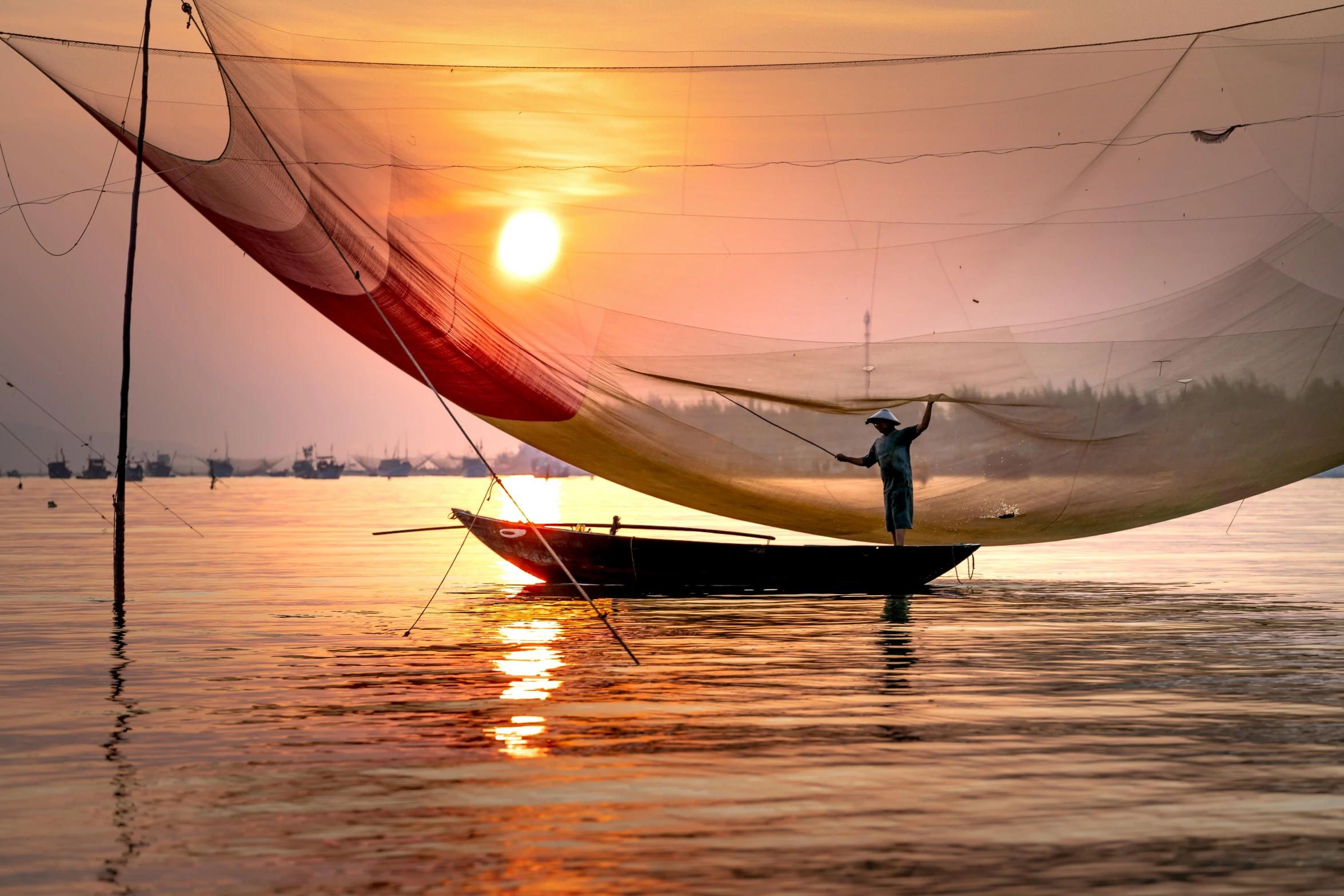 a man standing on top of a boat in the water, inspired by Steve McCurry, pexels contest winner, asian sun, ships with sails underneath, vietnamese woman, warm glow