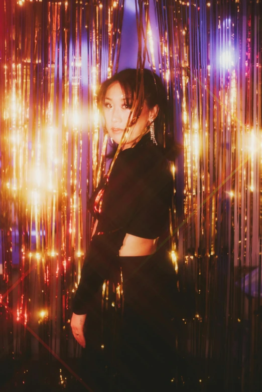 a woman standing in front of a wall of lights, an album cover, trending on pexels, ayami koj ima, party lights, official store photo, waist - up