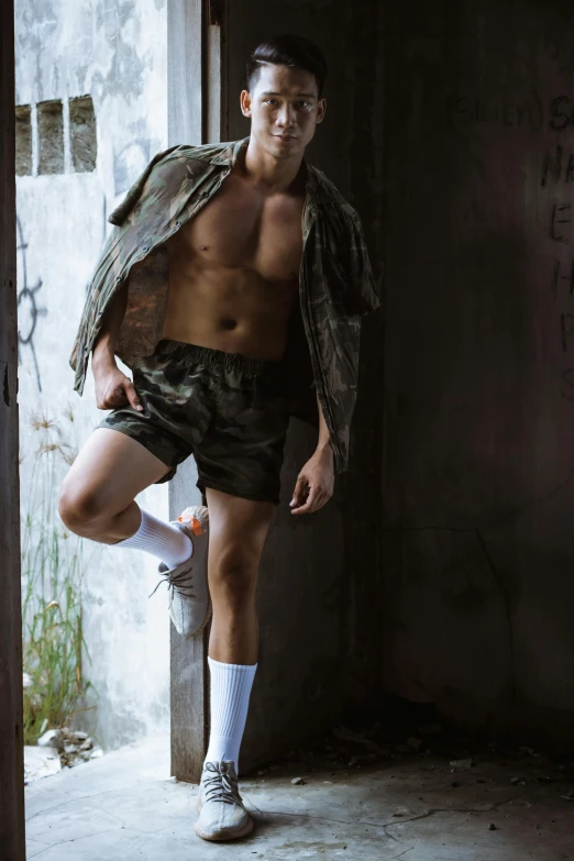 a man that is standing in a doorway, bra and shorts streetwear, military composure, lgbtq, slide show