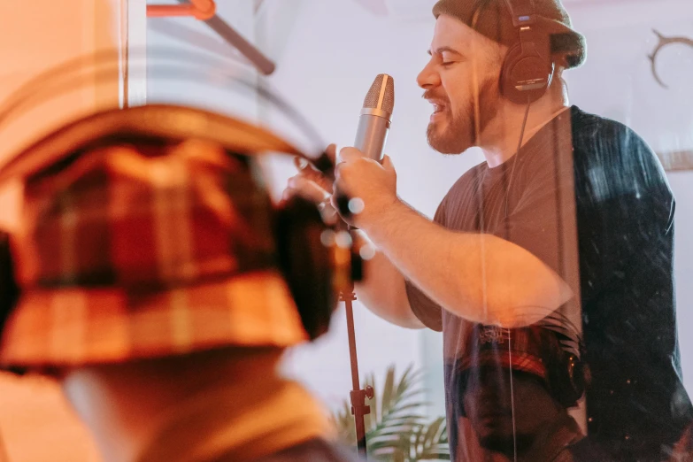 a man that is standing in front of a microphone, madhouse studio, thumbnail, lachlan bailey, profile image