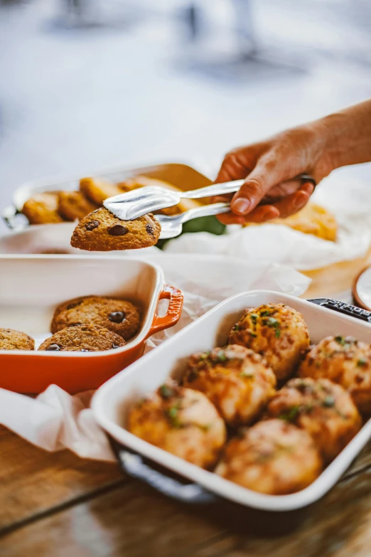 a wooden table topped with dishes of food, by Matt Cavotta, unsplash, holding meatloaf, pan and plates, square, white